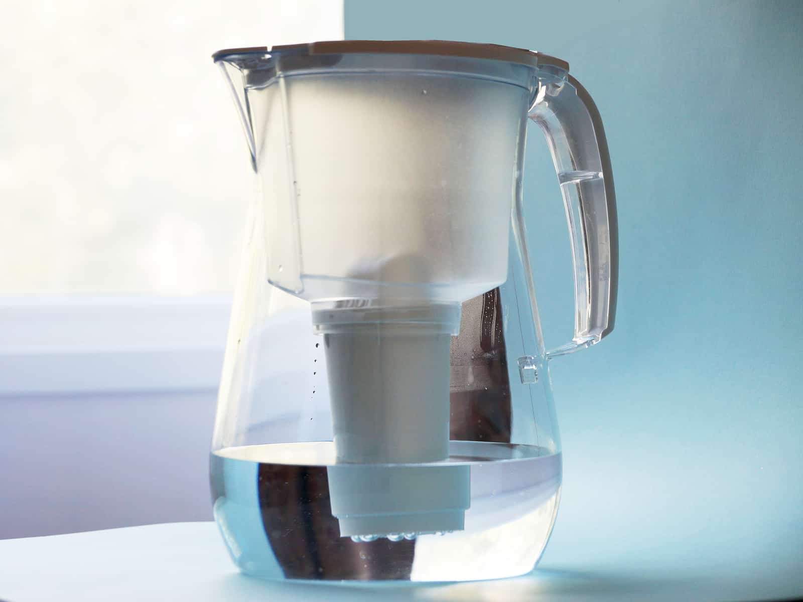 a jug for filtering water against the background of the window
