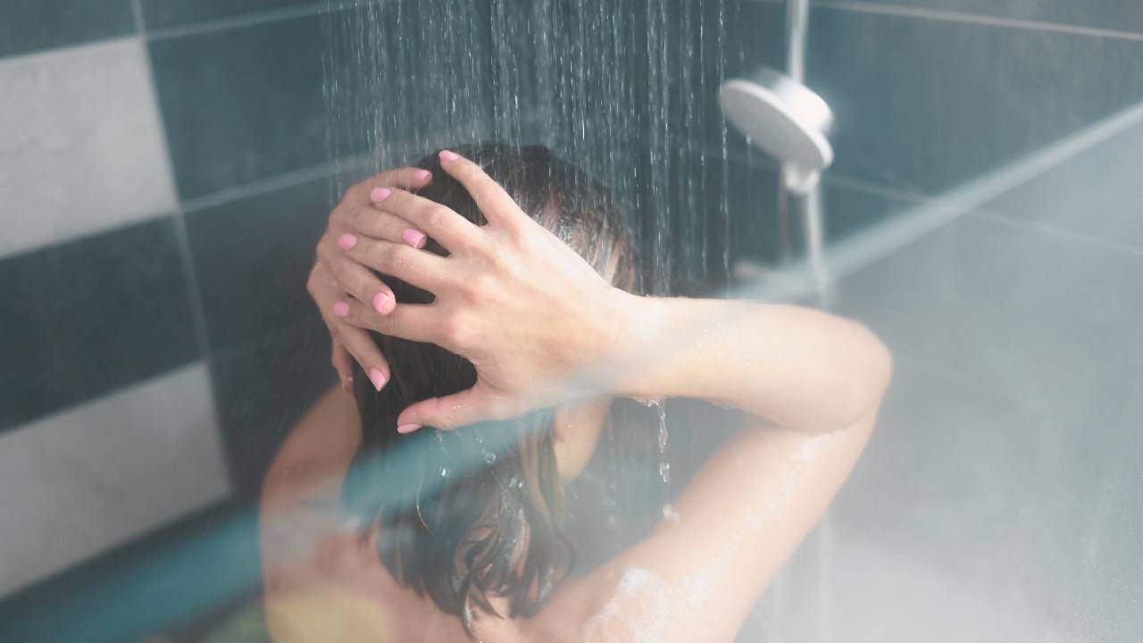 woman showering with showerhead filter