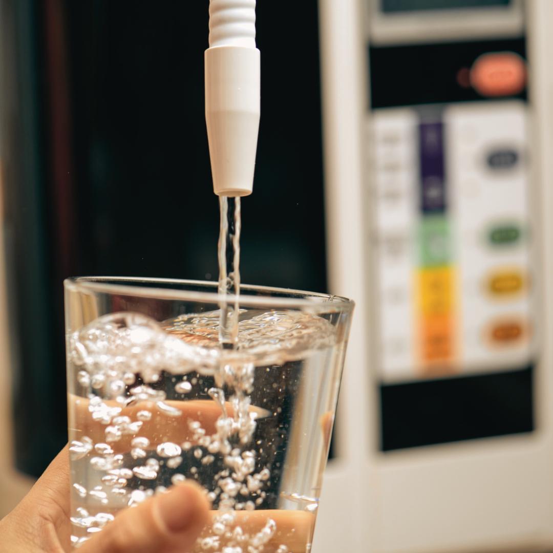 An alkaline water filter machine dispensing water into a glass 